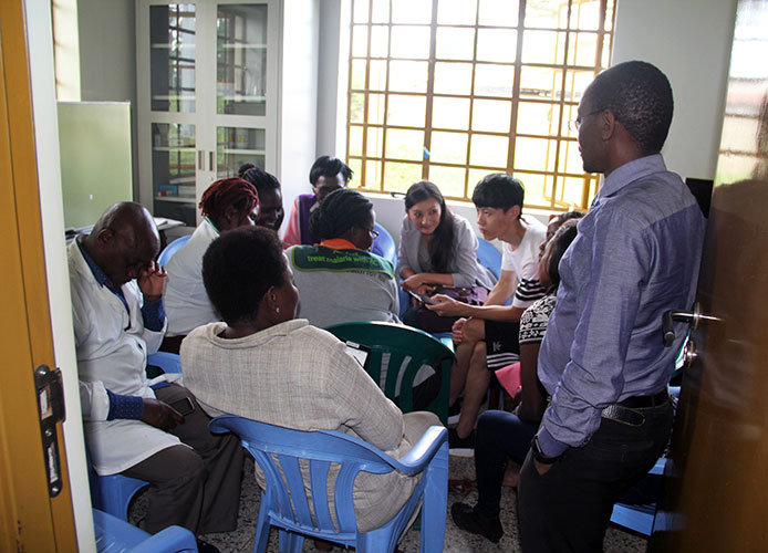 Photo of Yuehwern Yih & Dawei Wang teaching Ugandans