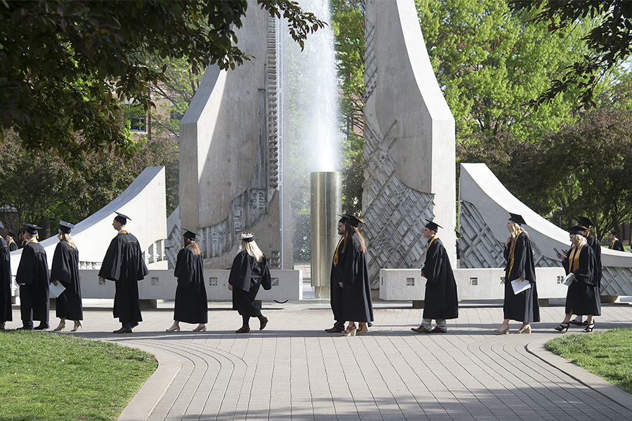 An Image of graduates in front of the fountain