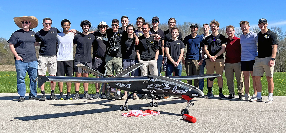 The Purdue Aerial Robotics Team standing with Guapo, their large fixed-wing UAV.
