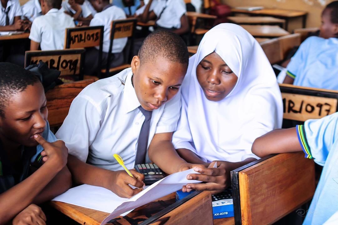 Students in a classroom working on a project together