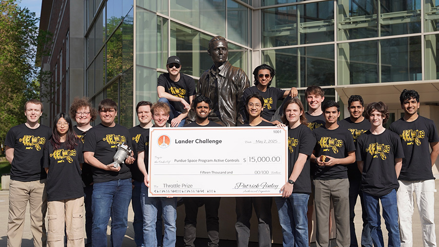 Group of students holding a $15,000 check