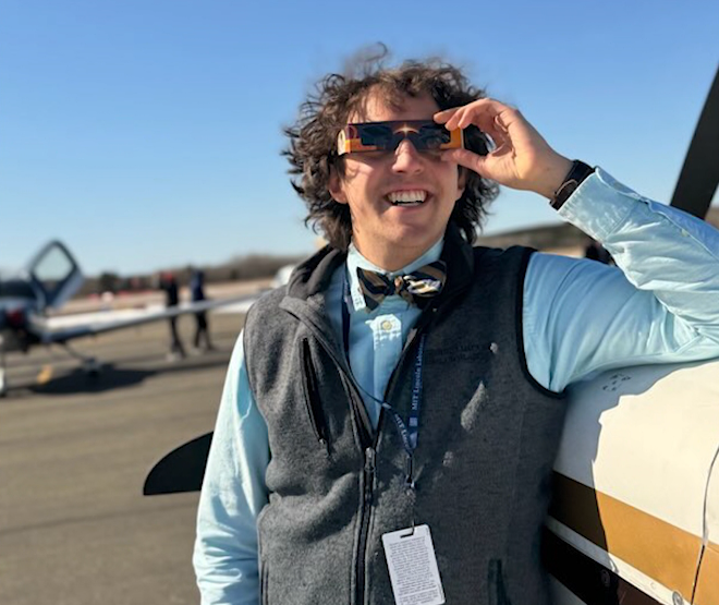 Geoffrey Andrews standing next to a small plane