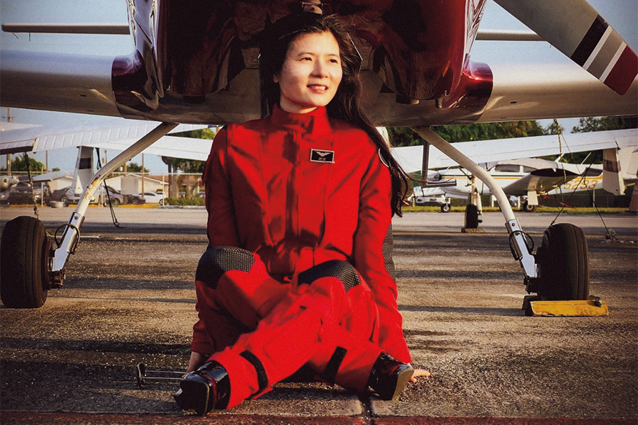 Anh-Thu Nguyen sitting in front of a small plane