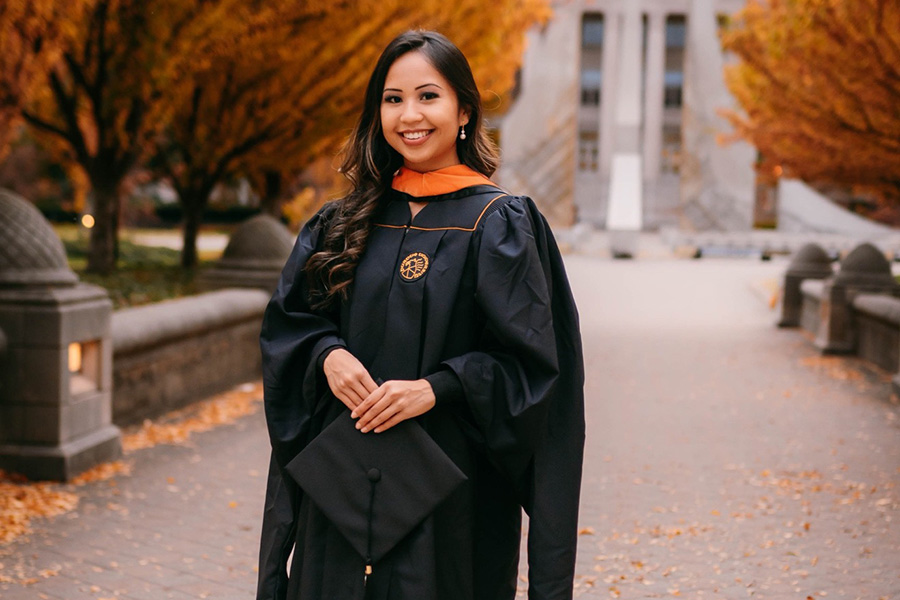 Portrait of Ellen Nguyen on the Purdue campus, with trees in full fall colors behind her.