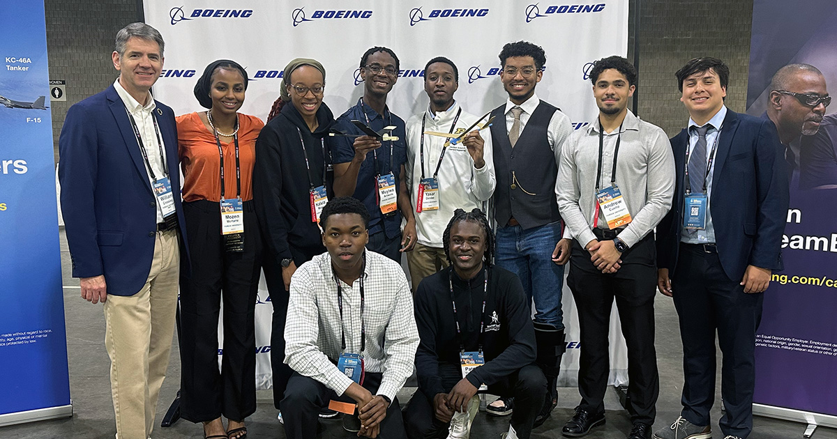 AAE head Bill Crossley stands with Purdue NSBE members who competed in the Boeing flight competition