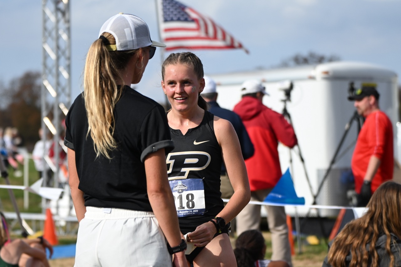Pegher talking to her coach after a race