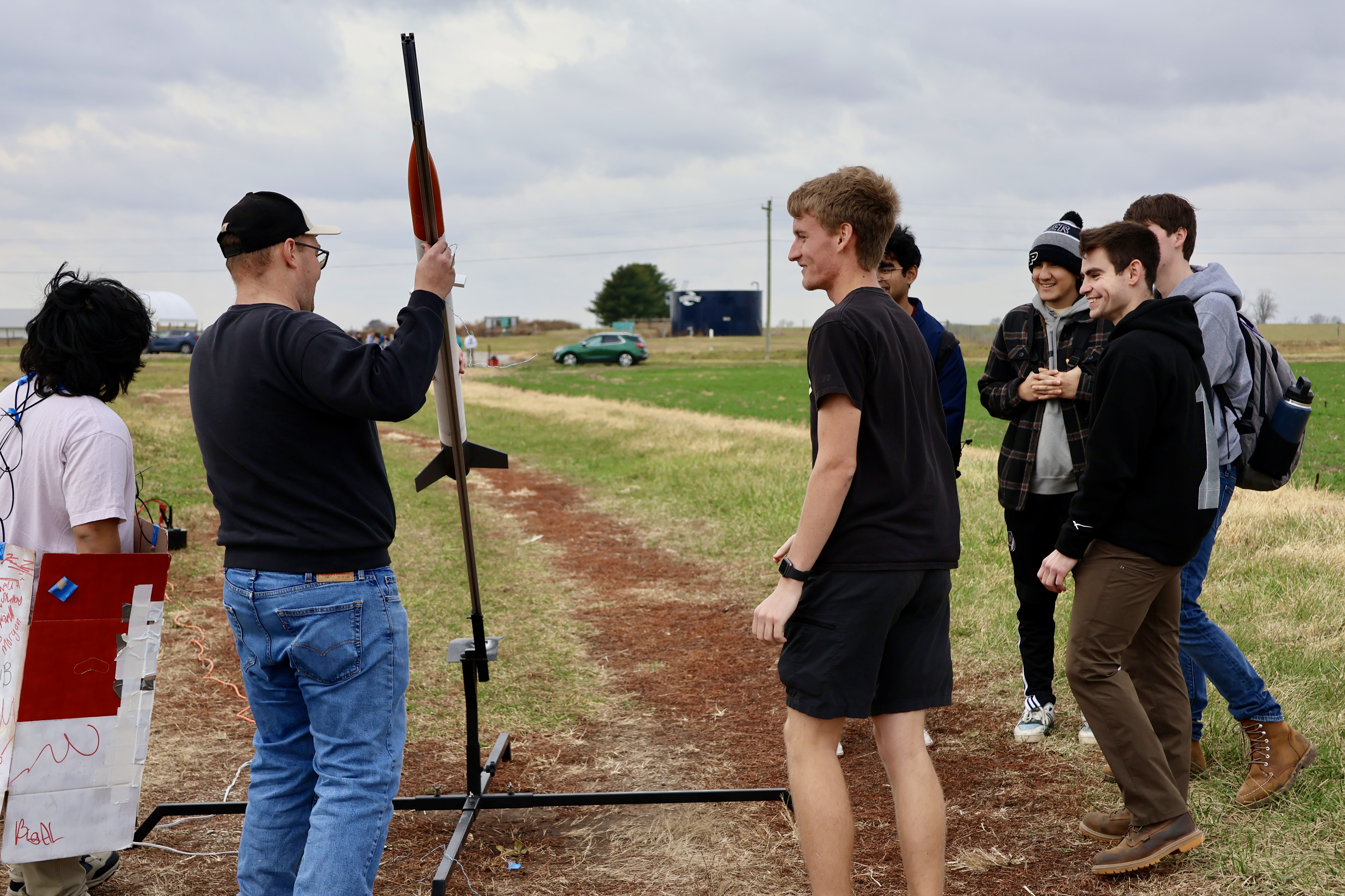 Students mount their rocket onto the launch rail before the flight test.