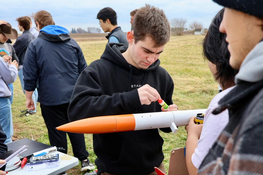 Students assemble their rocket and prepare the custom-designed motor before launch testing.