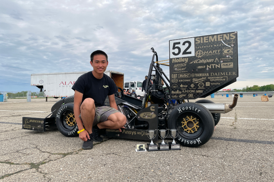 Zhang posing with one of his Formula SAE cars.
