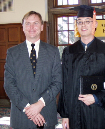 Gerald Lo stands with Prof. Farris at the 2003 AAE Graduation Reception