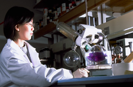 Student with microscope in lab