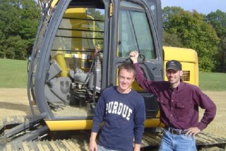 Students with earth-moving equipment