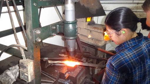 Image of Lena making knives