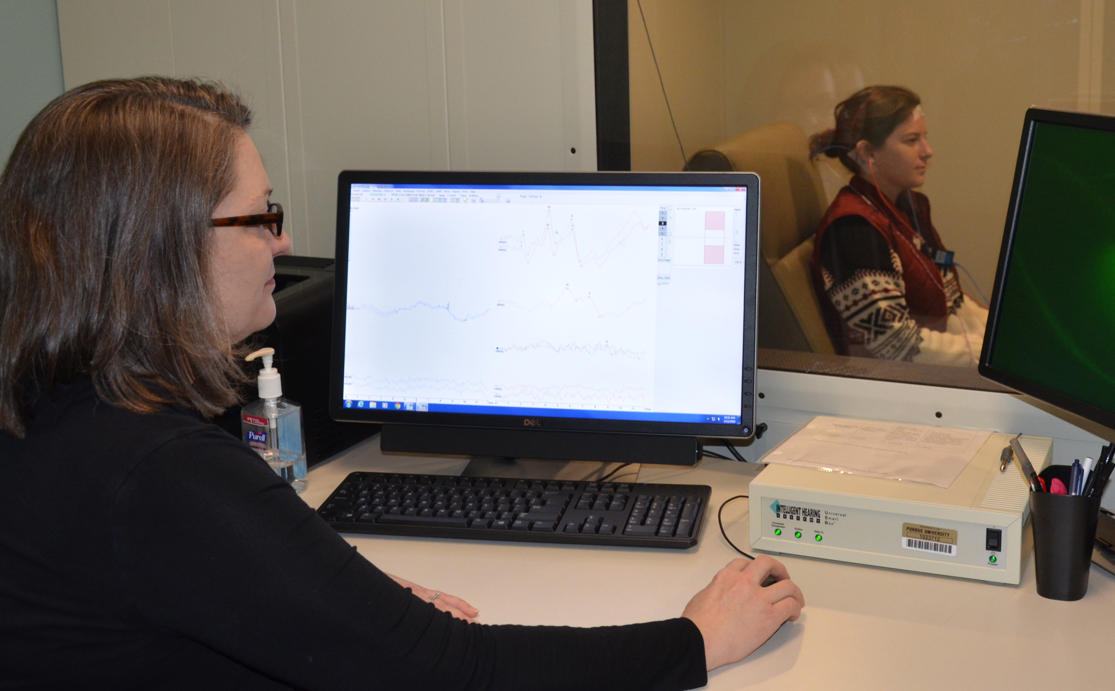 Jennifer Simpson (left) clinical professor and director of Clinical Education in Audiology conducts a hearing test at the Purdue Speech and Audiology Clinic.