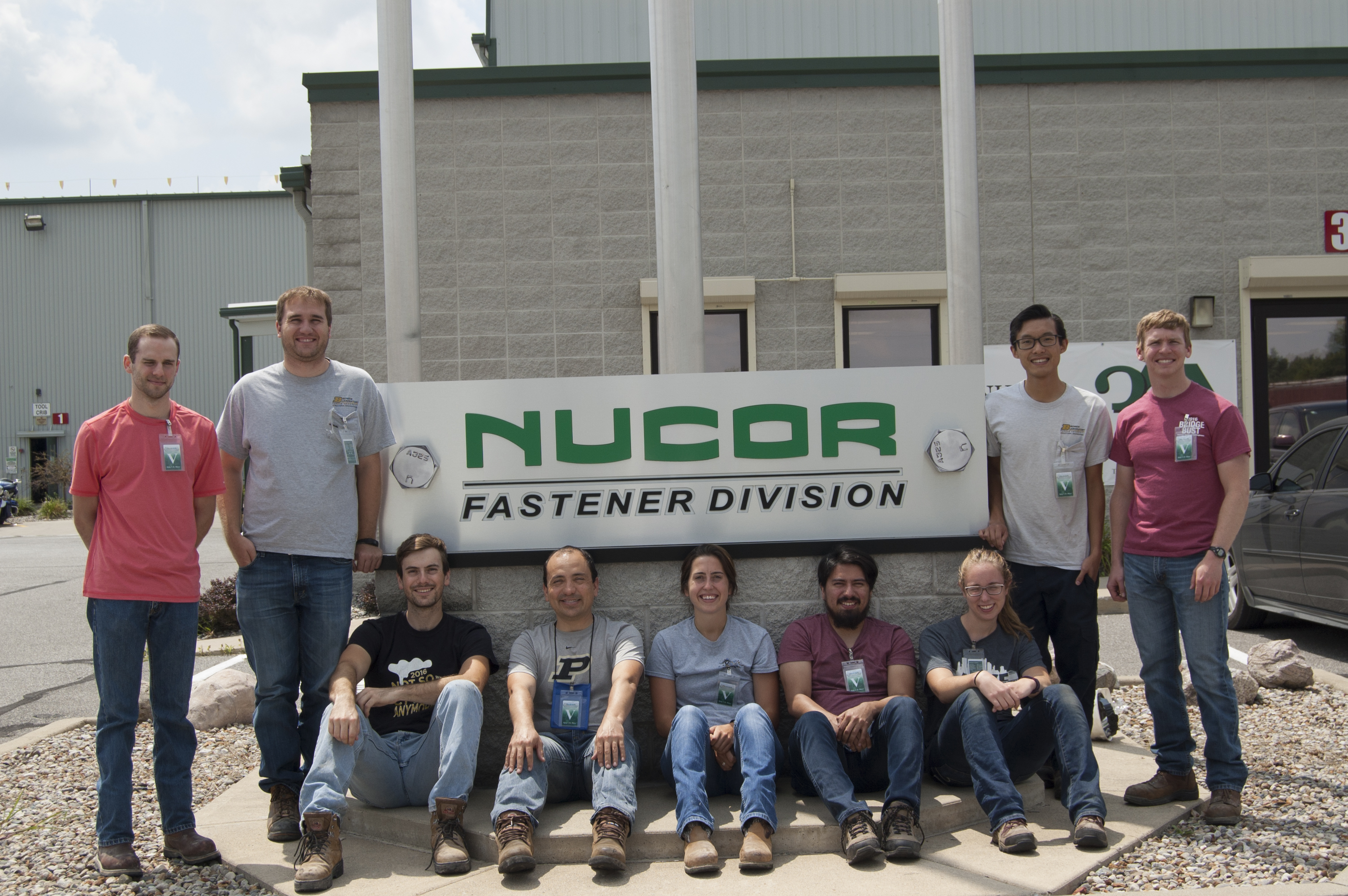 Group Photo in front of the Nucor Sign