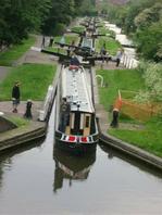 Students navigate the narrow boats through a set of staircase locks