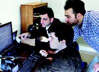 Thanos Tzempelikos (top left), associate professor of civil engineering; Iason Konstantzos (at computer), graduate student and Tzempelikos advisee; and Amir Sadeghi, graduate student and advisee of Panagiota Karava, associate professor of civil engineering. The group is discussing the results of experiments conducted in HLAB regarding human interactions with lighting and thermal systems in buildings.