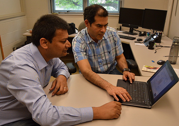 Lyles School of Civil Engineering Professor Venkatesh Merwade (right) and PhD candidate Siddharth Saksena review flood data collected from Hurricane Harvey.