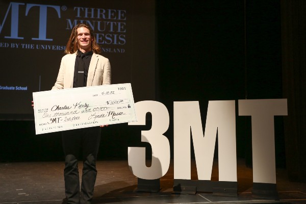 Charles Kerby receiving the award for second place finish in the 3MT competition