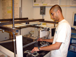 Gaurav Sant, undergraduate student, with research equipment