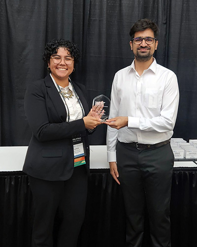 Purdue ITE chapter executive board members Lauren Jenkins and Mohammadhosein Pourgholamali accept the 2023 Student Chapter Award