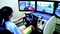 Graduate student Dong Yoon Song operates the Purdue Driving Simulator, which replicates automobile, traffic and weather conditions in and around Indianapolis. The DSL is located in the Purdue Technology Center.