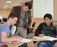 Cary Troy, associate professor of civil engineering, reviews the work done by students David Magarici (left) and Kentaro Hwang. Troy’s hydraulics class is set in an IMPACT classroom, which promotes a high level of interaction between students and teachers.