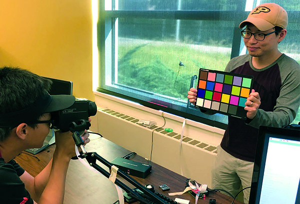 From left, Civil Engineering PhD students Joe Xiong and Seungjae Lee measure luminance levels at Herrick Laboratories. The data collected is then utilized to develop new algorithms for self-tuned indoor environments.
