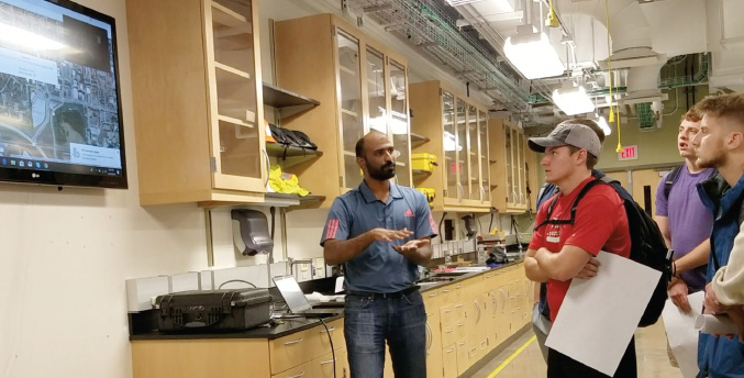 Transportation research engineer Mathew Jijo Kulathintekizhakethil explains to students in the Smart Mobility class how connected vehicles collect and transmit data.