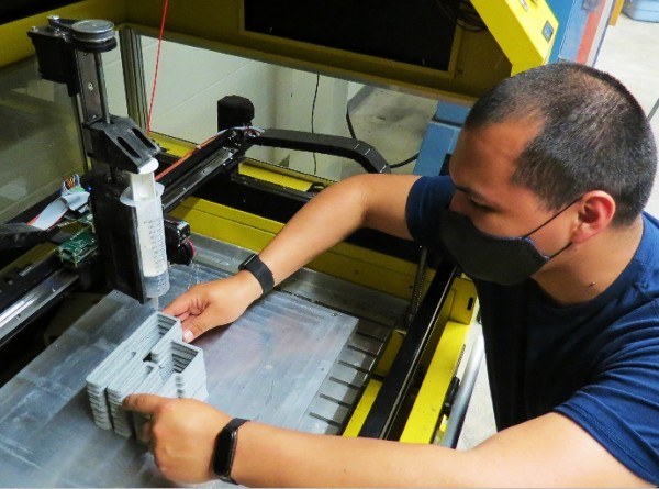PhD student Fabian Rodriguez monitors the progress of the latest 3D printing.