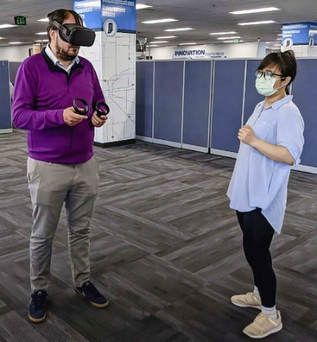 INDOT Assistant Statewide Maintenance Operations Engineer Andrew Blackburn (left) tests the VR module with Purdue civil engineering PhD student Yu-Ting Huang.