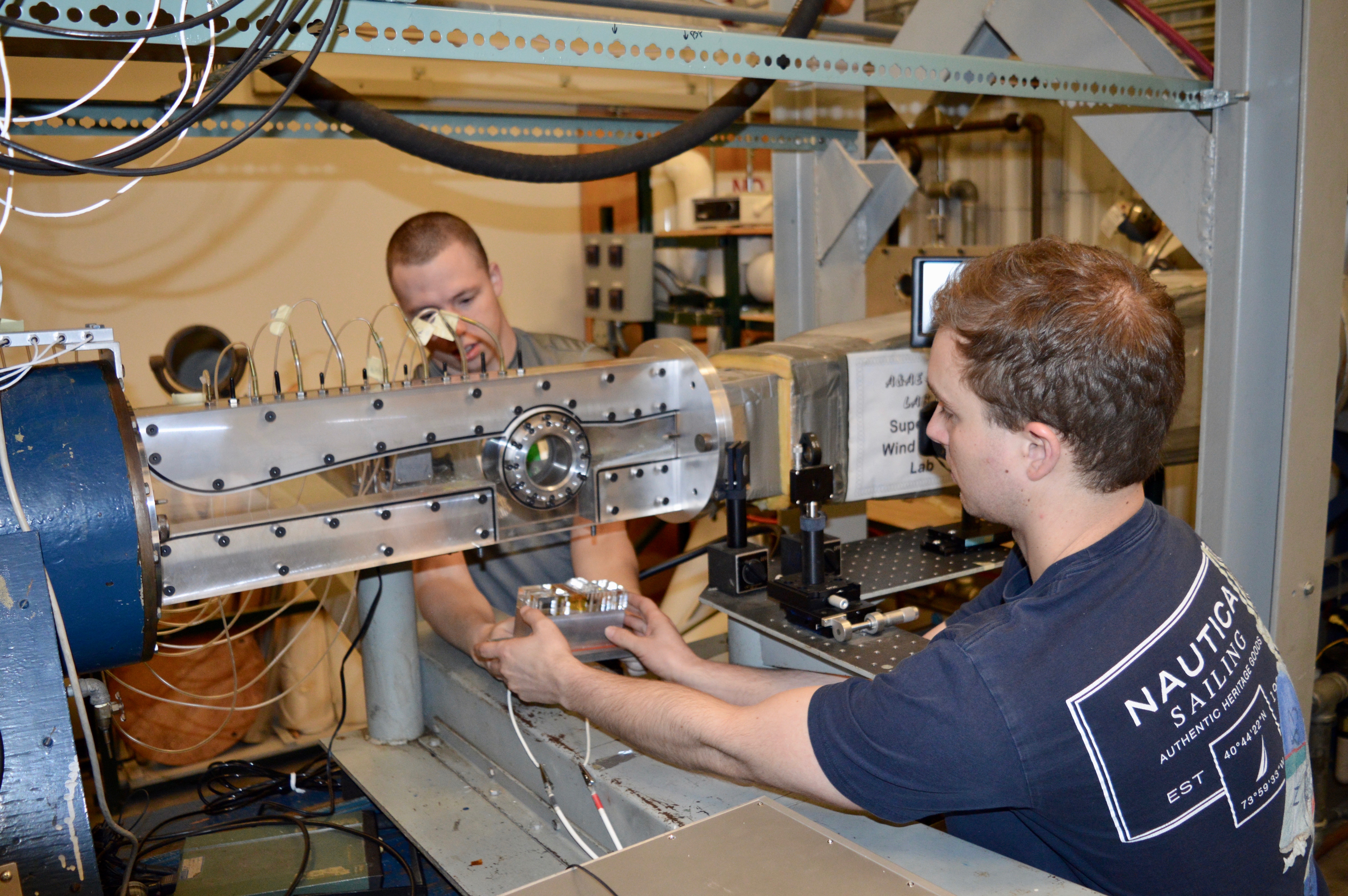 Paul Stockett (left) and Kyle Newnam (right) set up an actuator test in the supersonic wind tunnel at Purdue’s Aerospace Sciences Laboratory.