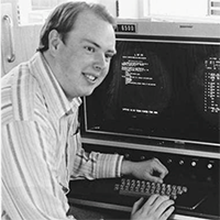 Portrait of George Goble at a computer terminal