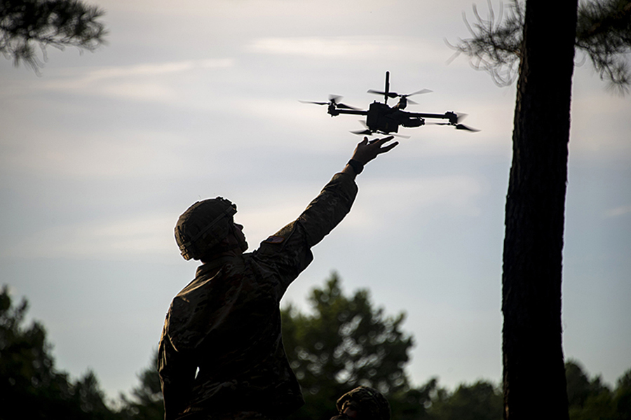 photo of soldier launching a drone