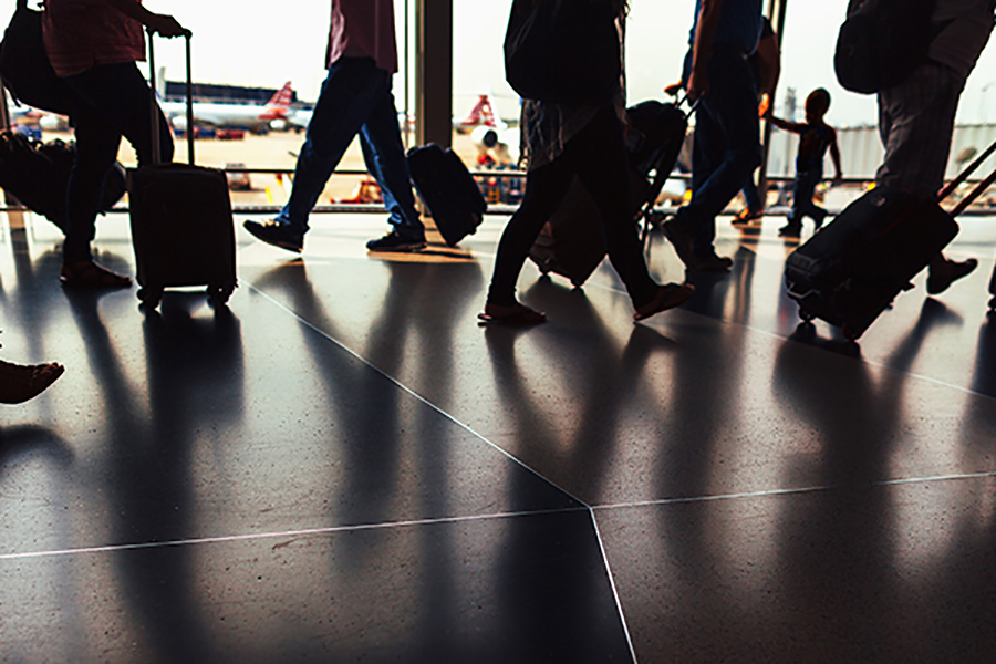 stock image of travelers in an airport