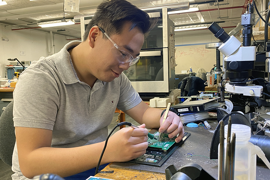Zecong soldering a board