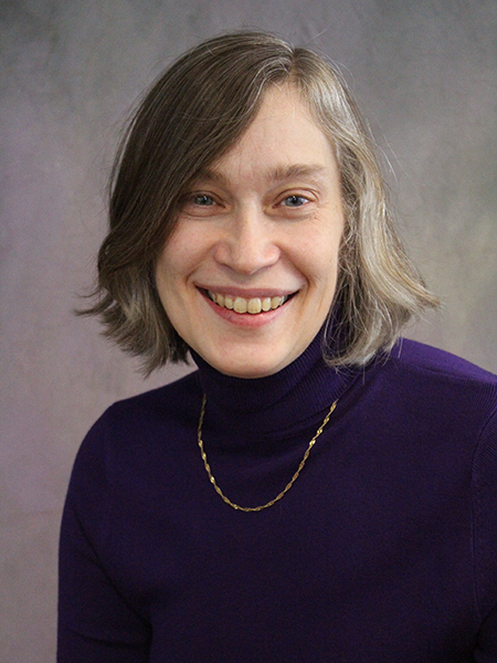 Portrait of Amy Reibman. She is wearing a dark turtleneck top and a necklace.