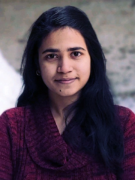 Headshot of PhD student Suparna Seshardi. She has long dark hair and is wearing a dark red sweater with a cowl neck.