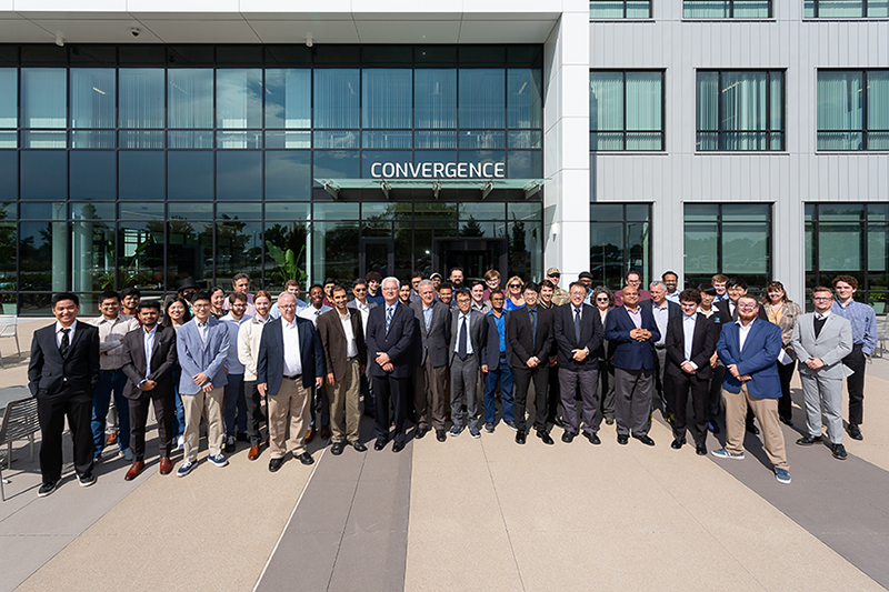 Participants of the annual meeting gather for a group photo in the front of the Convergence Center building.
