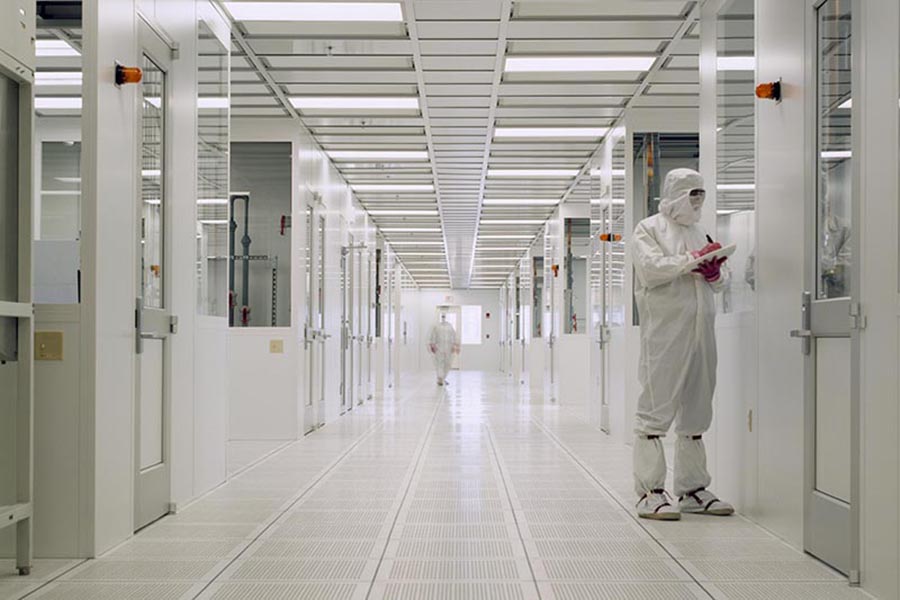 a scientist is dressed in a cleanroom work suit inspecting projects in the Birck Nanotechnology clearnroom