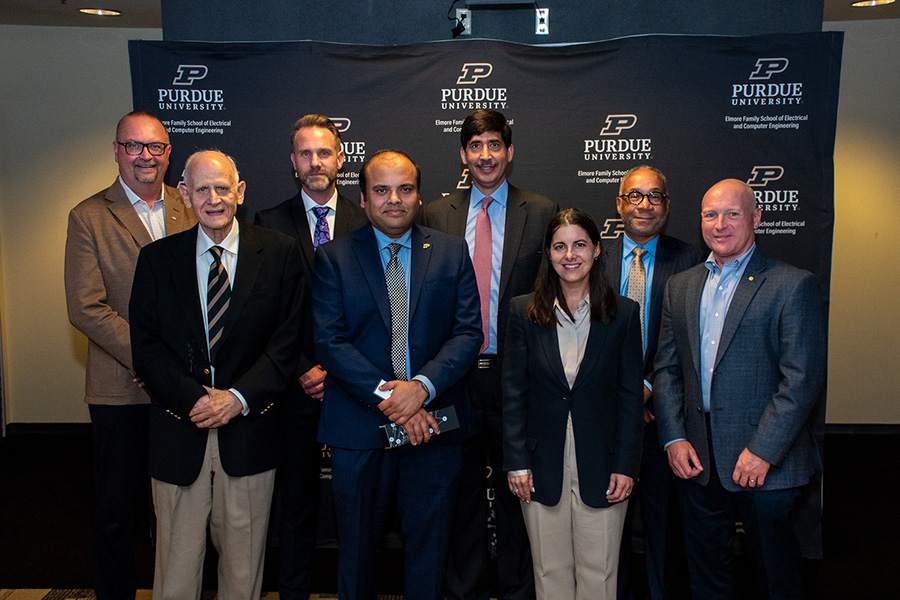 Group photos of honorees at the 2023 OECE awards. They are standing in front of the Purdue ECE branded back drop. From left: Matt Folk, Barrett Robinson, Nic Radford, Arijit Raychowdhury, Sohail Naqvi, Kristen Daihes, Shawn Williams, and ECE alumni Dave Beering.