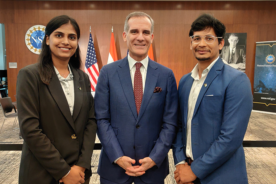 Pooja Chaudhary, PhD student; Eric Garcetti, U.S. ambassador to India; and Mahindra Rautela stand together.