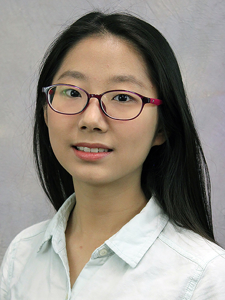 Portrait of Tong Yao wearing glasses and a white button up shirt