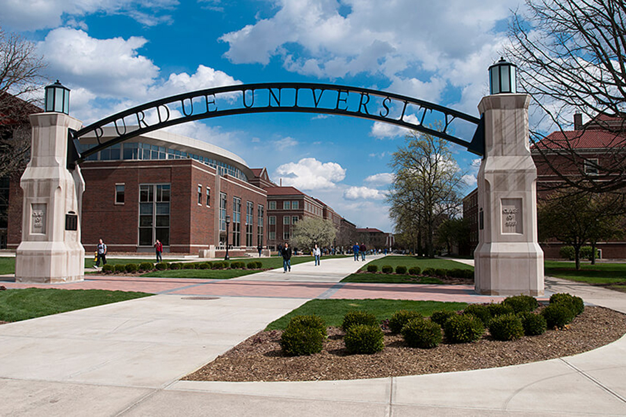 Photograph of the Engineering Gateway Arch on Purdue's campus. In the background is a sunny sky and engineering buildings.