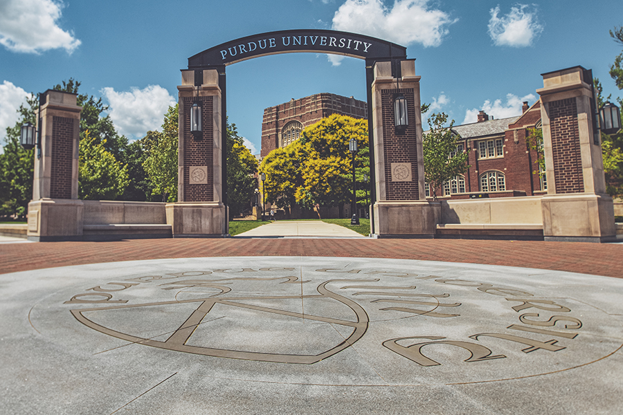 located just southeast of the purdue memorial union, the gateway arch is a brick and steel structure that reads purdue university. in the foreground, the purdue seal is imprinted onto the concrete