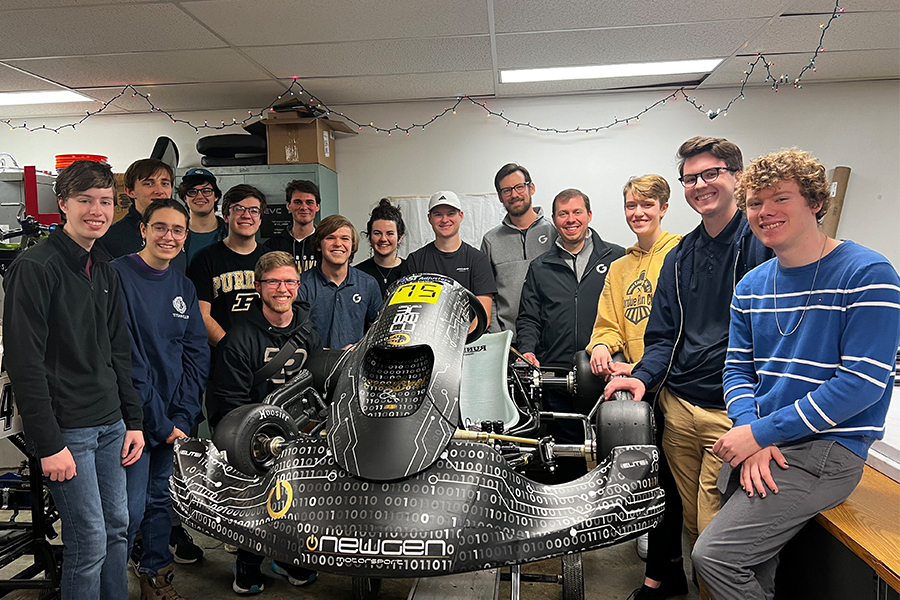 Members of the Purdue Electric Vehicle Club pose around the electric vehicle they built