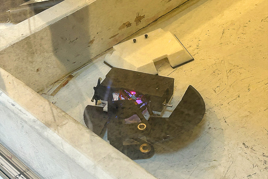 A black battlebot and a white battlebot ready for battle