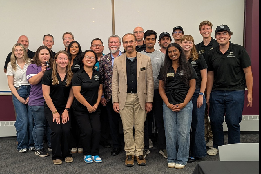 Purdue ECE students, faculty and industry representatives pose together for a group photo at a career fair event.