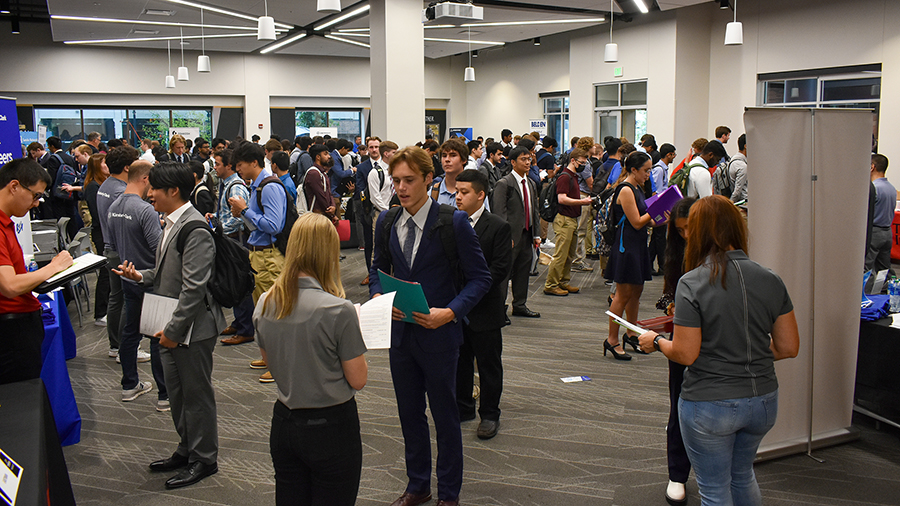 students lined up to meet with recruiters at job fair