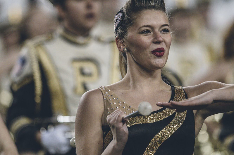 Emma performing with her baton at Purdue football half time